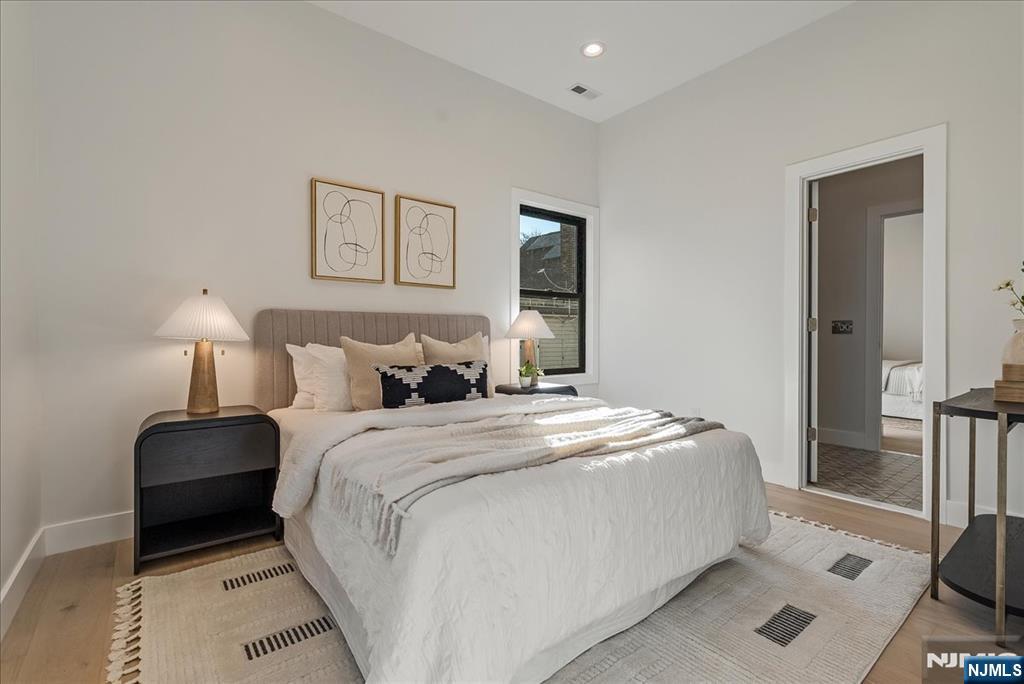 36 James Street Montclair, NJ 07042 - Photo 31 of 48 a bedroom with a bed and a lamp