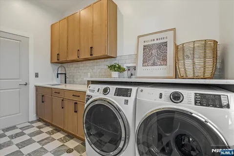 a utility room with multiple dryer and washer