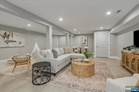 a living room with furniture a rug and a flat screen tv