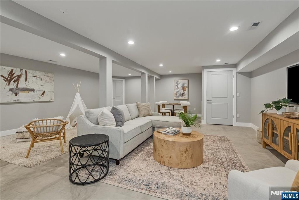 36 James Street Montclair, NJ 07042 - Photo 36 of 48 a living room with furniture a rug and a flat screen tv