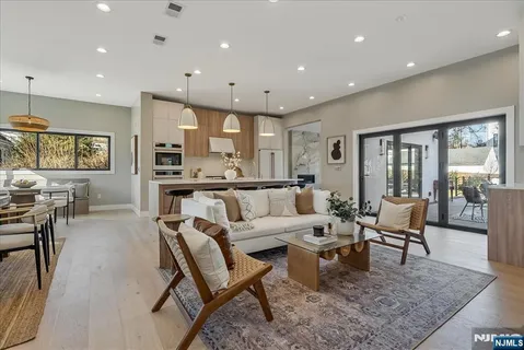 a living room with furniture wooden floor and a large window