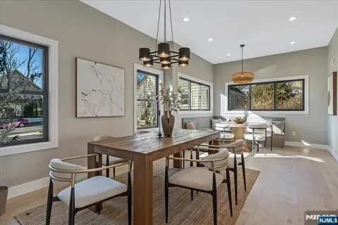 a view of a a dining room with furniture window and wooden floor