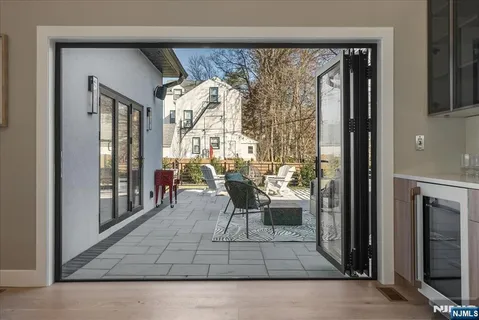 a living room with a large window and furniture