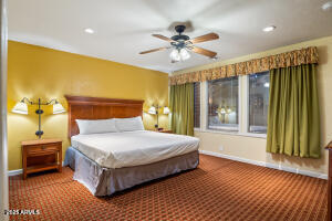 5829 East Buck Springs Road, Unit 201 Pinetop, AZ 85935 - Photo 1 of 23 a bedroom with a bed and a chandelier