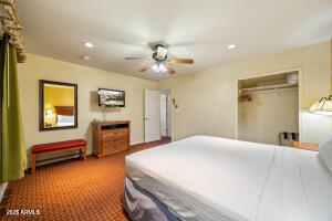 5829 East Buck Springs Road, Unit 201 Pinetop, AZ 85935 - Photo 2 of 23 a bedroom with a bed and a chandelier