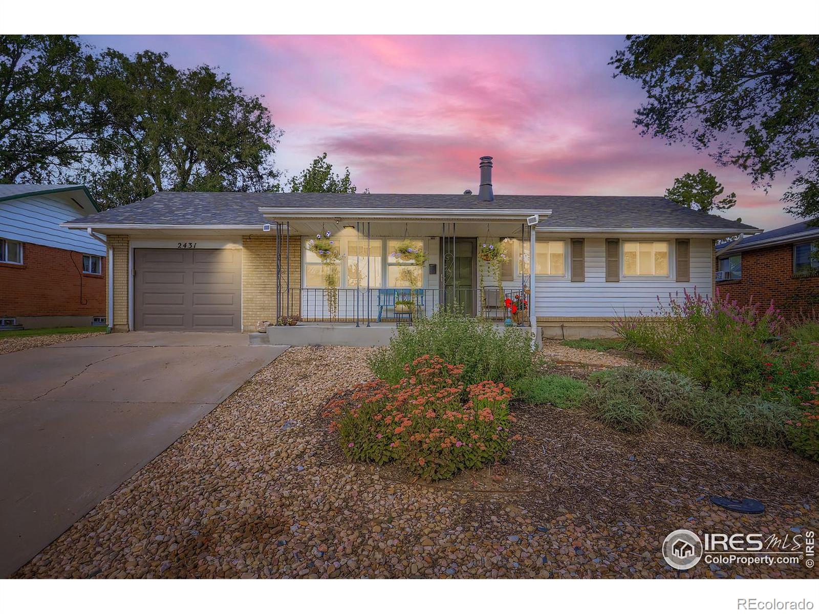 2431 West 24th Street Greeley, CO 80634 - Photo 1 of 32 a front view of a house with a yard and garage