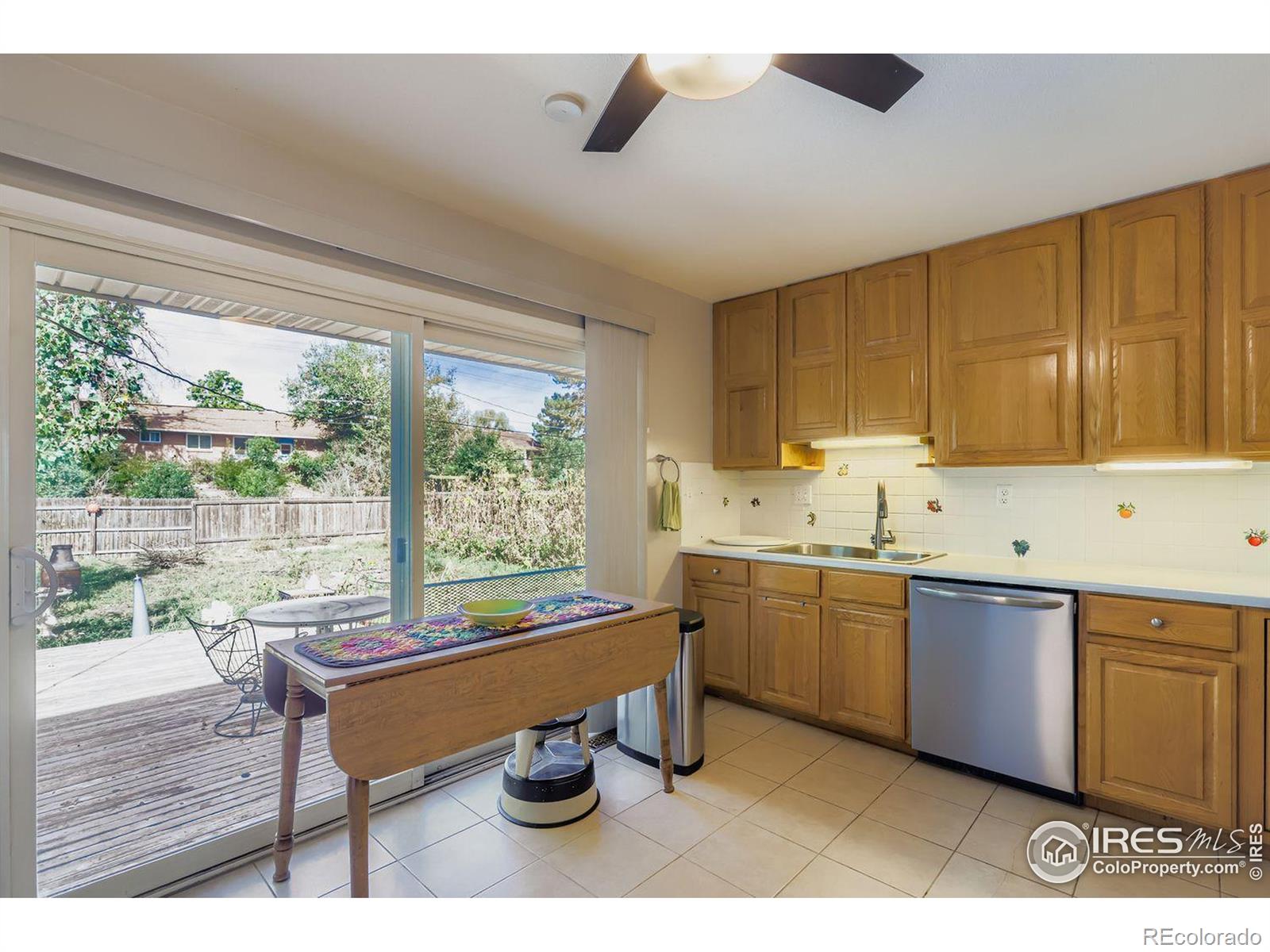 2431 West 24th Street Greeley, CO 80634 - Photo 11 of 32 a kitchen with sink cabinets and wooden floor