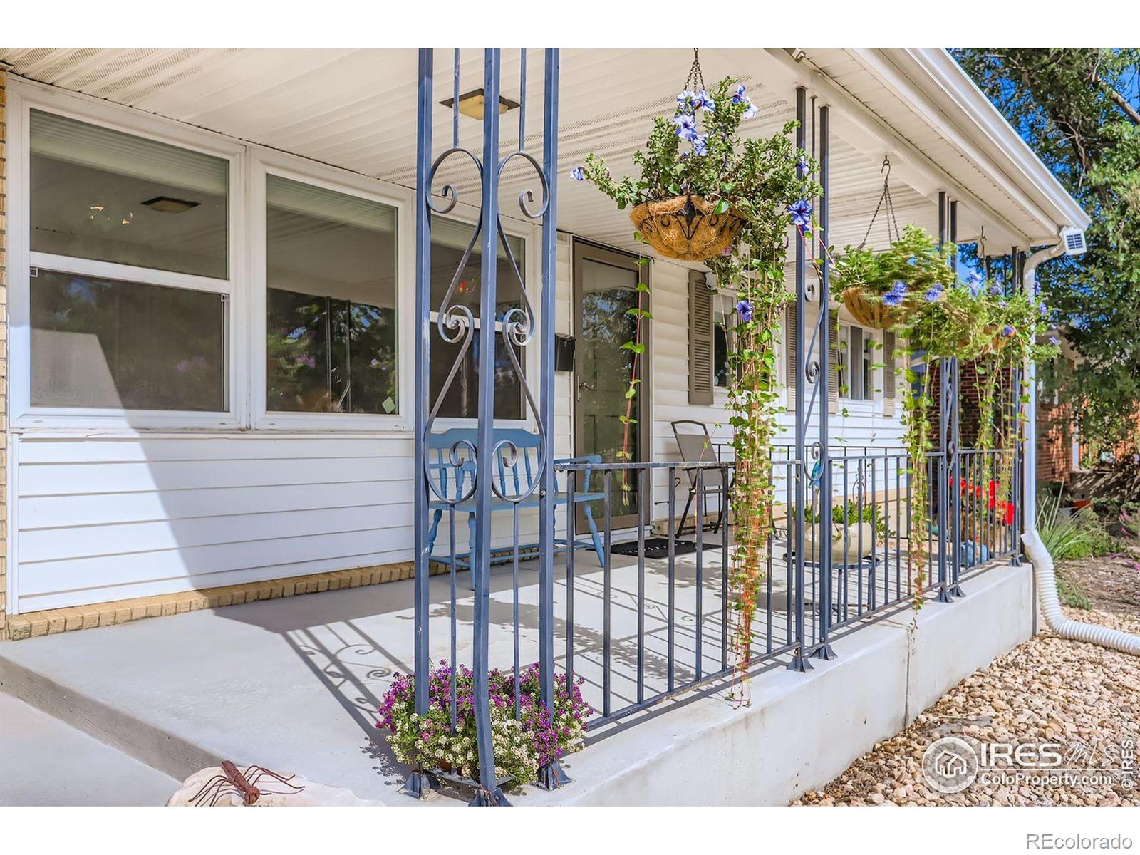 2431 West 24th Street Greeley, CO 80634 - Photo 4 of 32 a view of a house with a flower garden