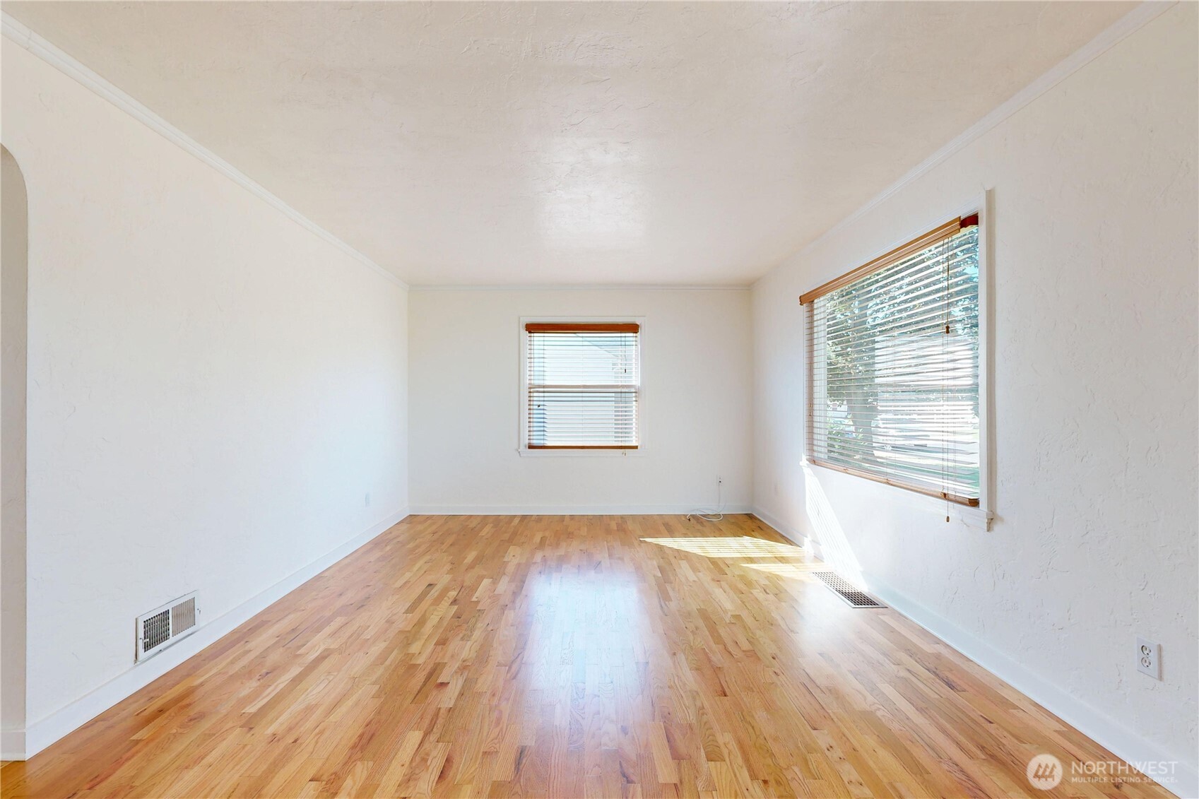 1303 Modoc Street Walla Walla, WA 99362 - Photo 13 of 40 an empty room with wooden floor and windows