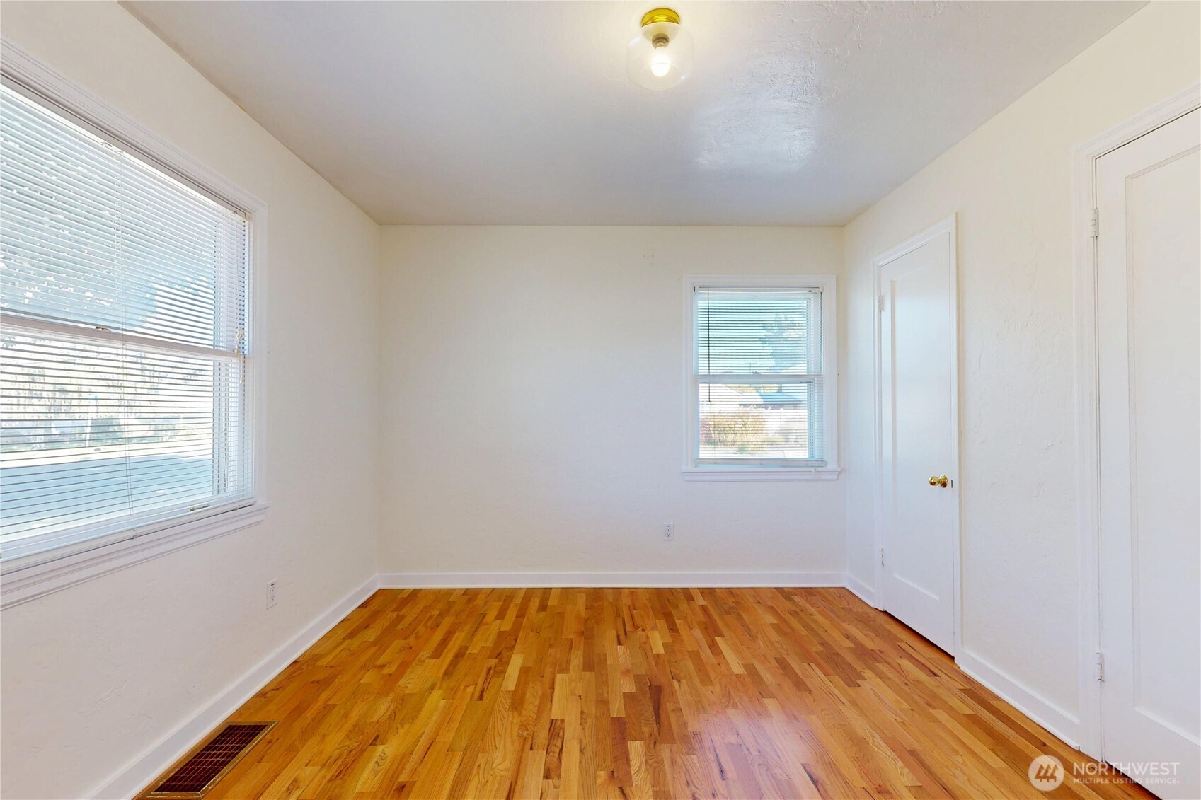 1303 Modoc Street Walla Walla, WA 99362 - Photo 18 of 40 an empty room with a window and wooden floor