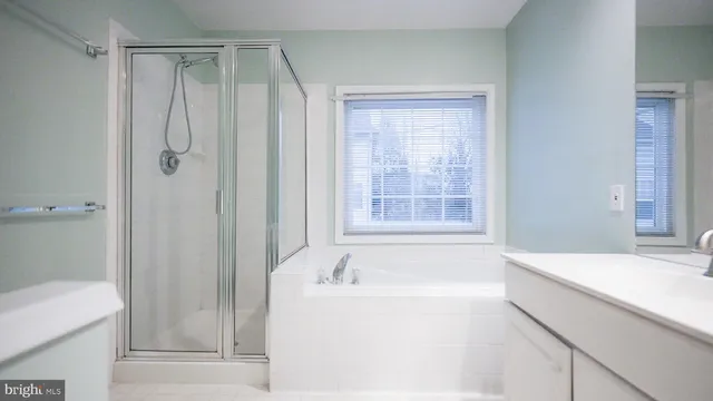 a bathroom with a bathtub and a shower