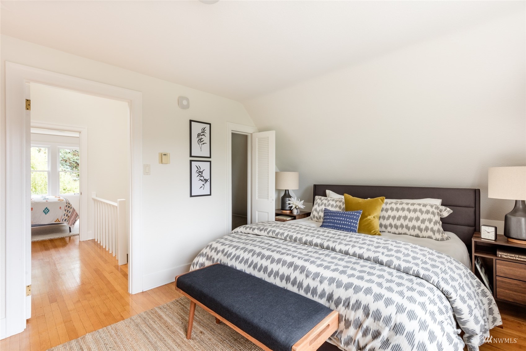 1724 31st Avenue Seattle, WA 98122 - Photo 24 of 34 a bedroom with a bed and wooden floor