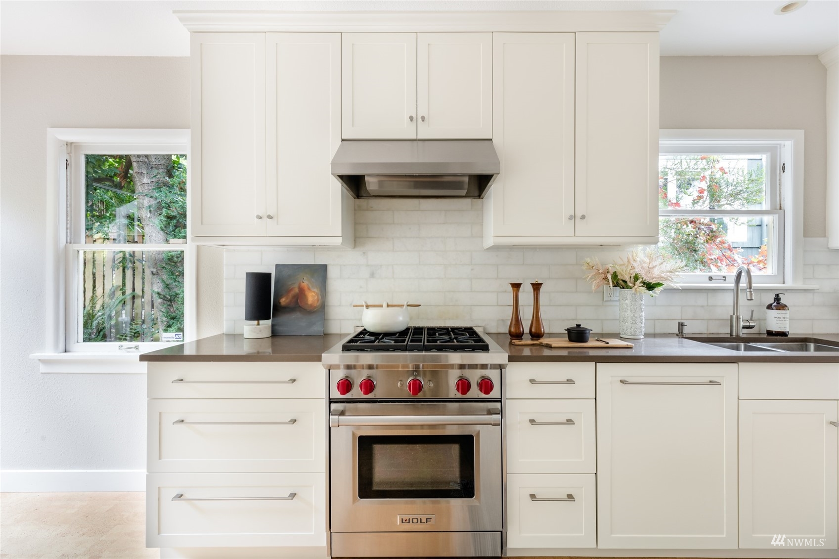 1724 31st Avenue Seattle, WA 98122 - Photo 9 of 34 a kitchen with granite countertop a stove sink and cabinets