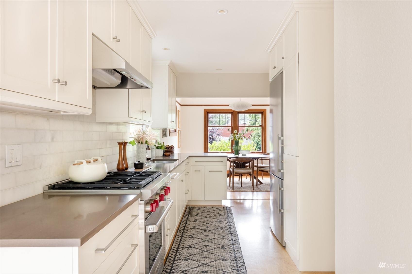 1724 31st Avenue Seattle, WA 98122 - Photo 10 of 34 a kitchen with a sink stove and cabinets