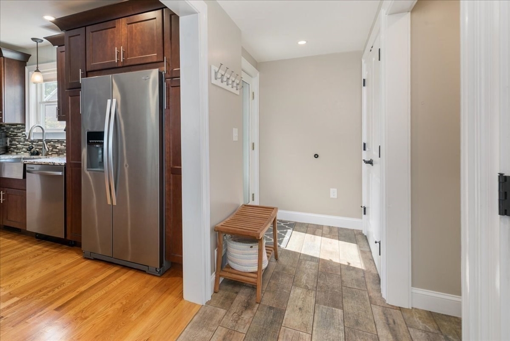 17 Old Essex Road Manchester, MA 01944 - Photo 13 of 40 a view of a kitchen with refrigerator and wooden floor