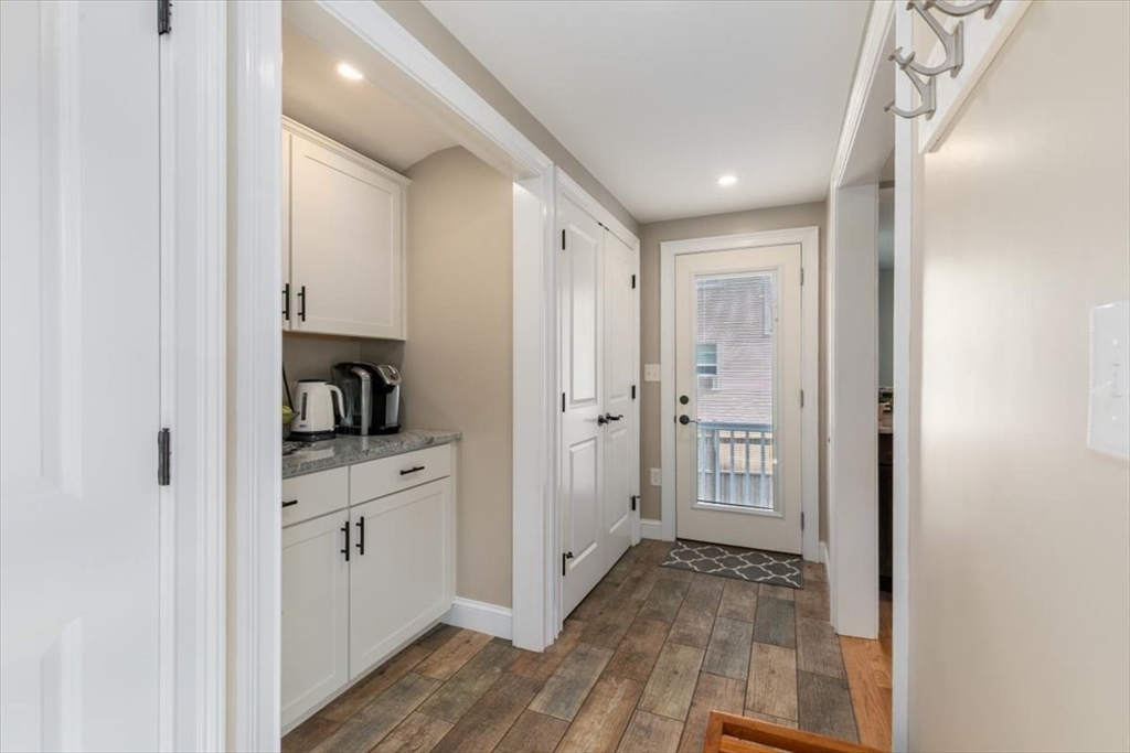17 Old Essex Road Manchester, MA 01944 - Photo 17 of 40 a view of a hallway to a room with wooden floor and closet