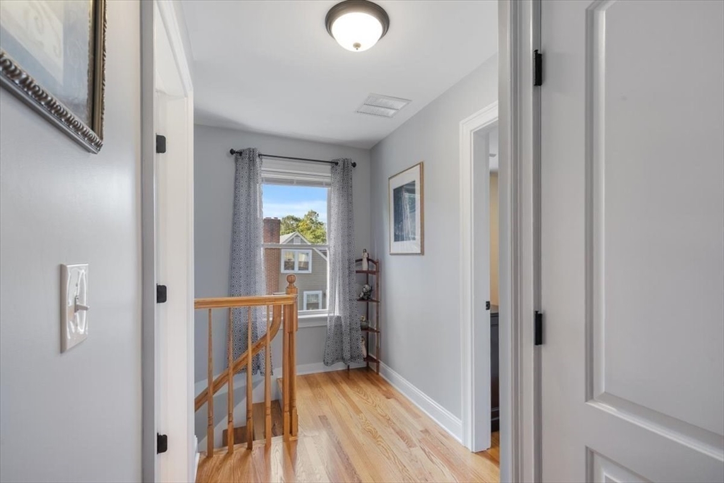 17 Old Essex Road Manchester, MA 01944 - Photo 22 of 40 a view of a hallway with wooden floor and staircase
