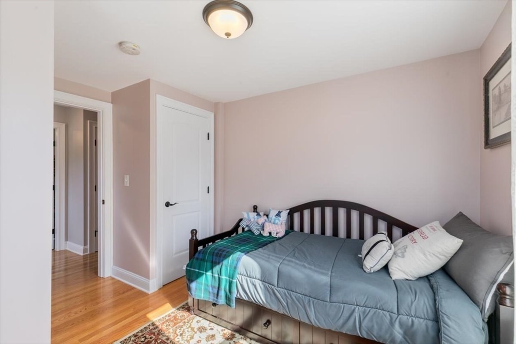 17 Old Essex Road Manchester, MA 01944 - Photo 24 of 40 a bedroom with a bed and wooden floor