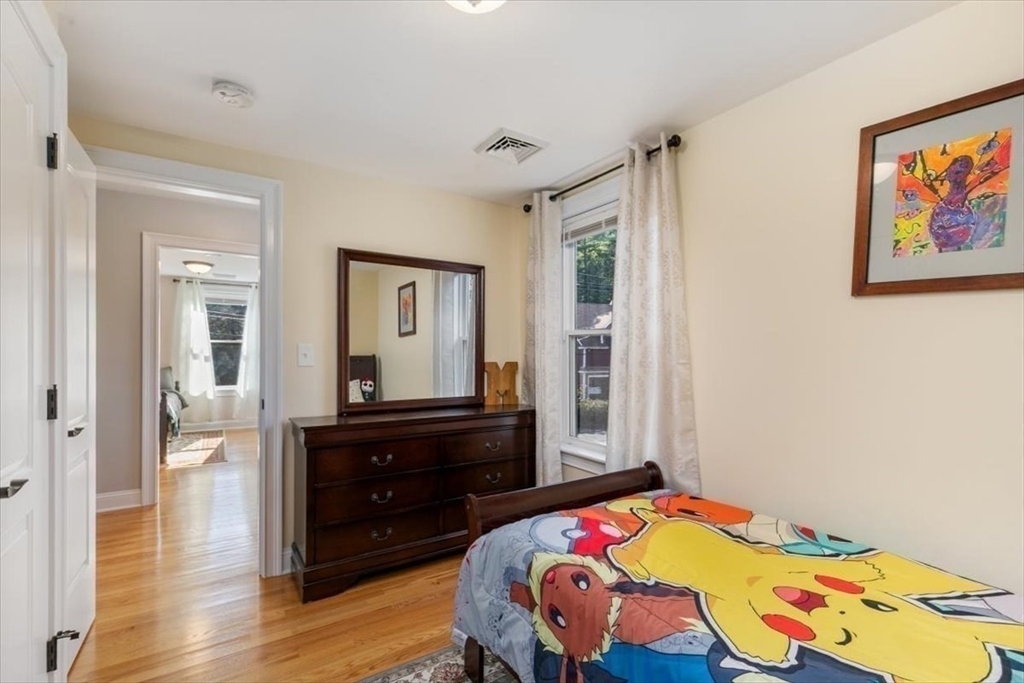 17 Old Essex Road Manchester, MA 01944 - Photo 25 of 40 a bedroom with a bed and wooden floor