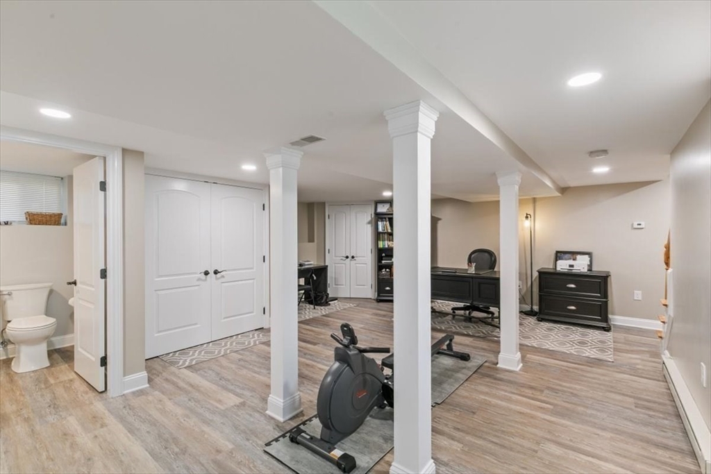 17 Old Essex Road Manchester, MA 01944 - Photo 28 of 40 a view of a room with gym equipment and wooden floor