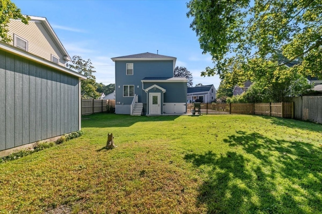 17 Old Essex Road Manchester, MA 01944 - Photo 36 of 40 a view of a backyard with a small cabin and chair