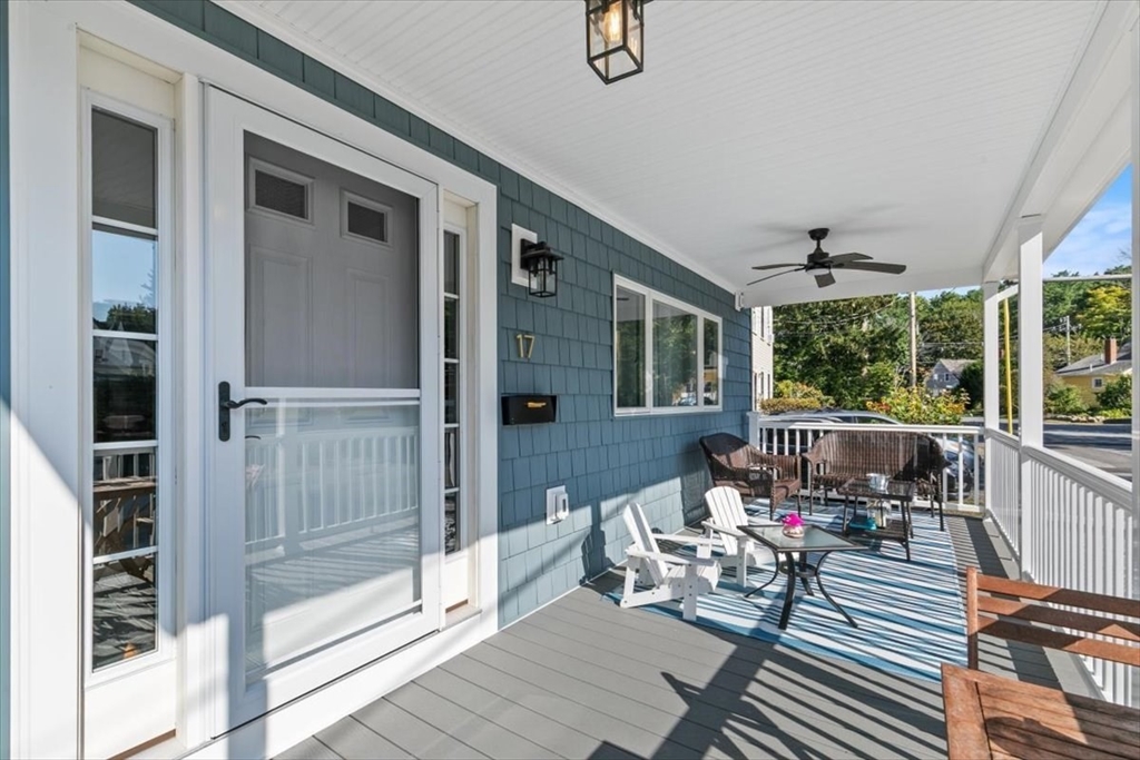 17 Old Essex Road Manchester, MA 01944 - Photo 4 of 40 a balcony with couch and wooden floor