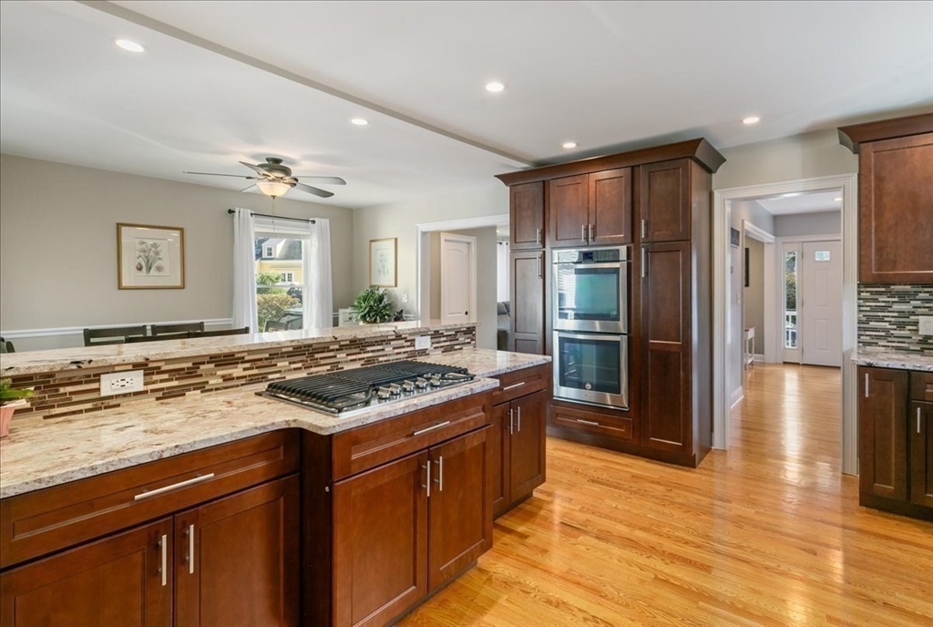 17 Old Essex Road Manchester, MA 01944 - Photo 9 of 40 a kitchen with stainless steel appliances granite countertop a stove refrigerator and dishwasher with wooden floor