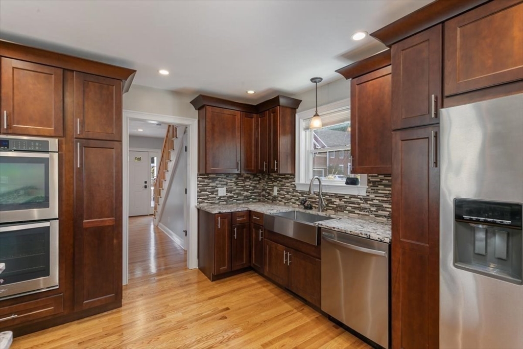 17 Old Essex Road Manchester, MA 01944 - Photo 10 of 40 a kitchen with stainless steel appliances granite countertop a refrigerator and a stove