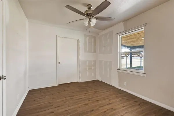 a view of an empty room with wooden floor