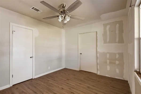 a view of hallway with a large window and wooden floor