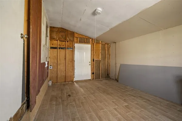 a view of a hallway with wooden shelves