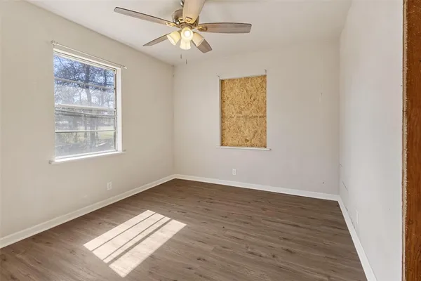 a bathroom with a granite countertop sink toilet a mirror and shower