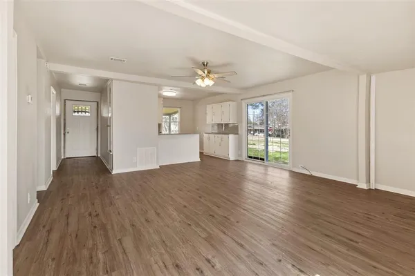 a view of a kitchen with a sink and a refrigerator