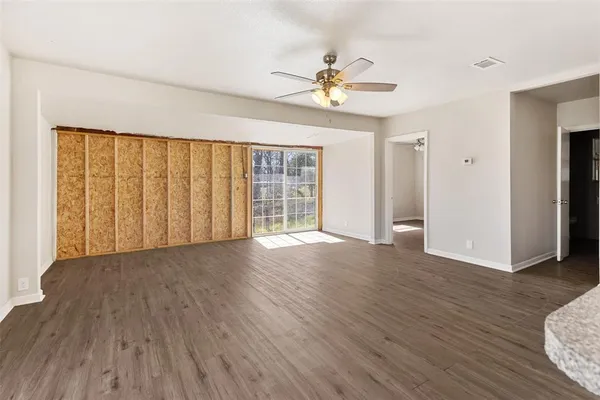a kitchen with granite countertop a sink a counter top space and cabinets
