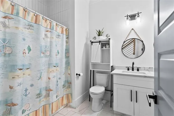 a bathroom with a toilet sink and mirror