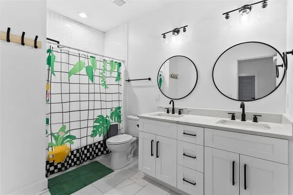 a bathroom with a double vanity sink and a mirror