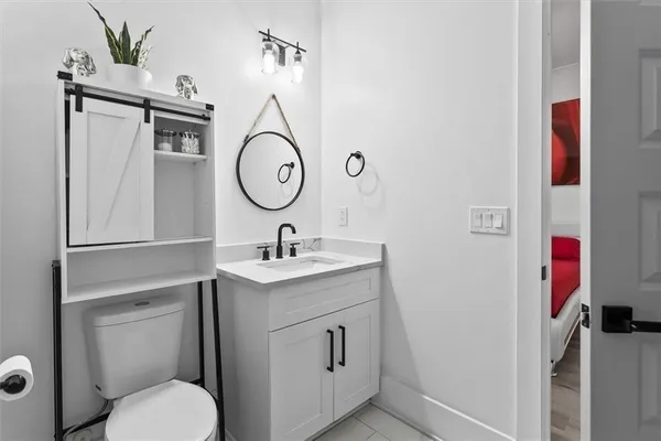 a bathroom with a toilet sink and mirror