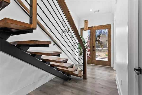 a room with wooden floor and furniture