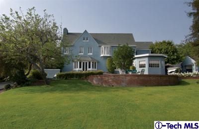 Undisclosed Address Pasadena, CA 91106 - Photo 1 of 1 a front view of a house with a yard and garage