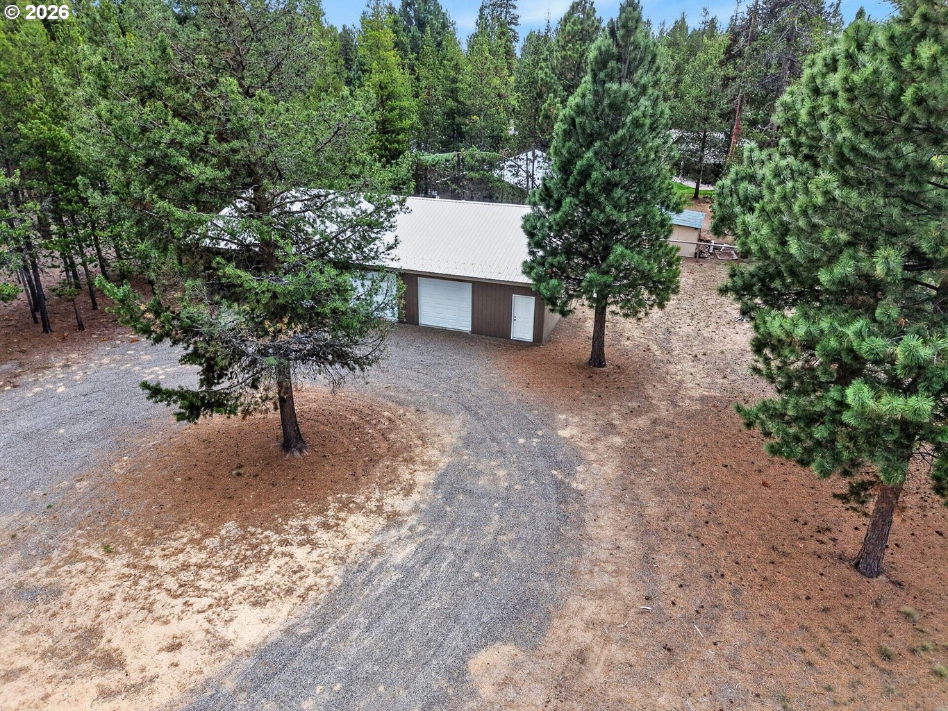 52628 Ammon Road, Unit 3 La Pine, OR 97739 - Photo 28 of 37 a view of a house with a tree and a yard