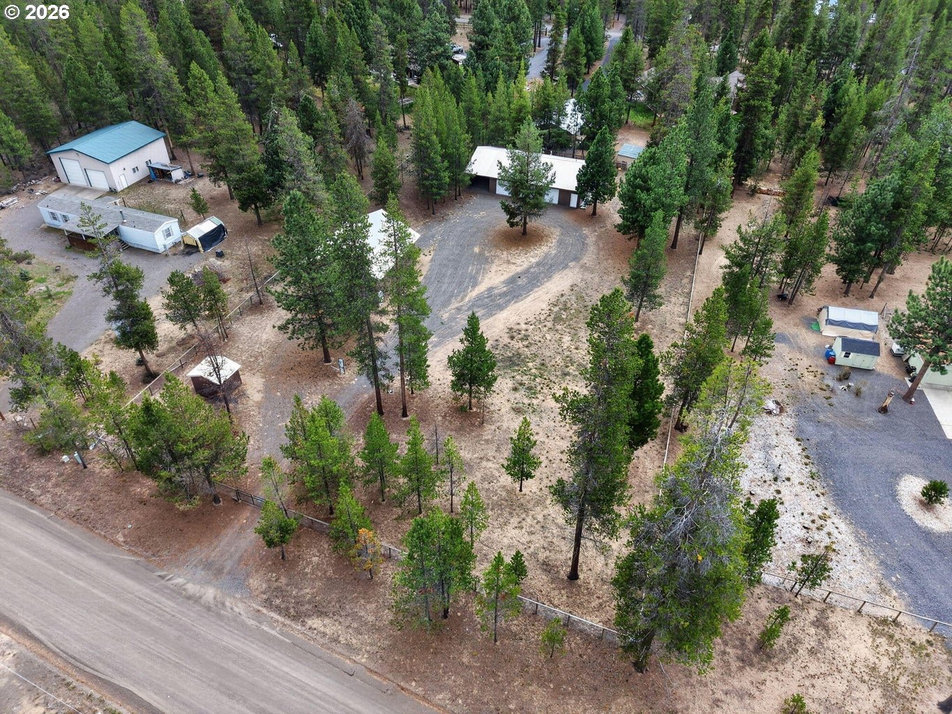 52628 Ammon Road, Unit 3 La Pine, OR 97739 - Photo 33 of 37 an aerial view of a house with a yard and garden