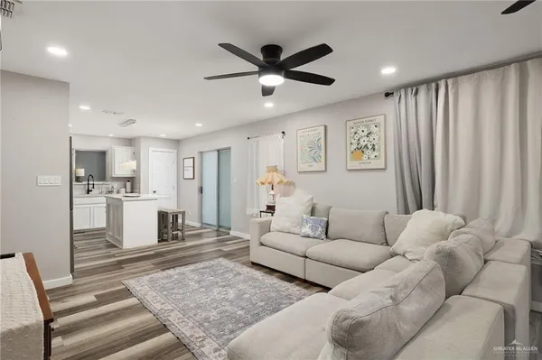 a living room with furniture and kitchen view