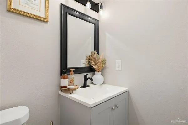 a bathroom with a sink vanity and a mirror
