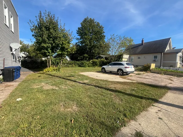 a backyard of a house with table and chairs
