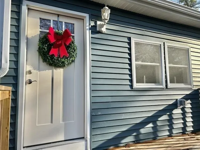 a vase of flowers sitting on a window sill and a window