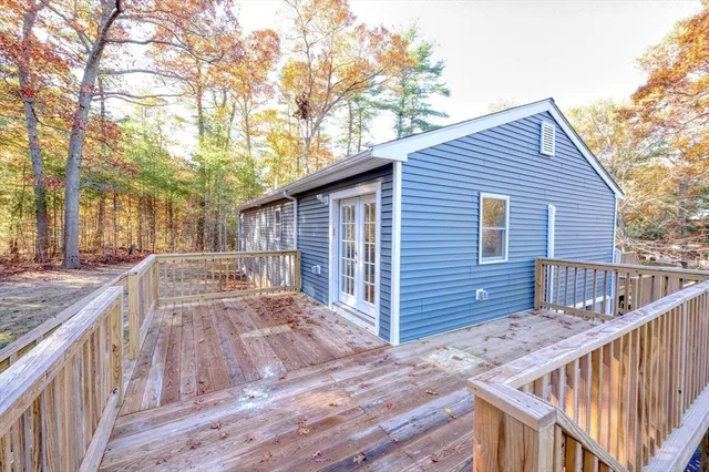 a view of backyard with deck and wooden floor