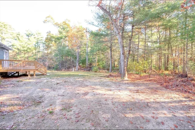 a view of a room with wooden floor and white walls