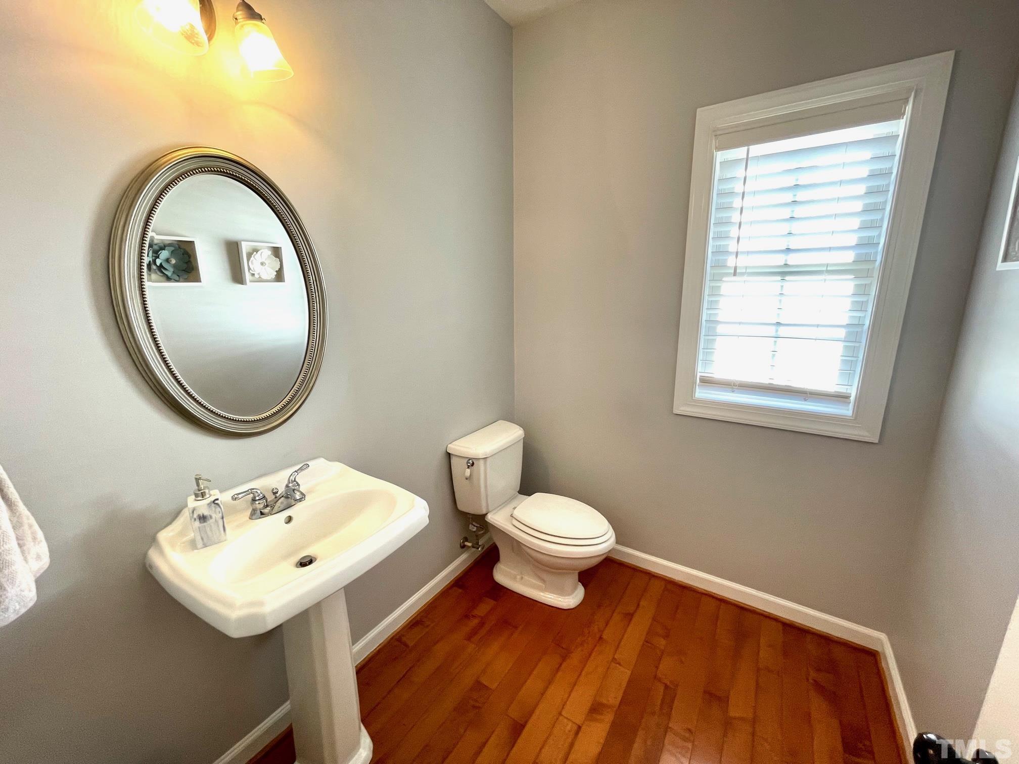 115 Beckford Road Cary, NC 27518 - Photo 25 of 50 a bathroom with a toilet a sink and a mirror