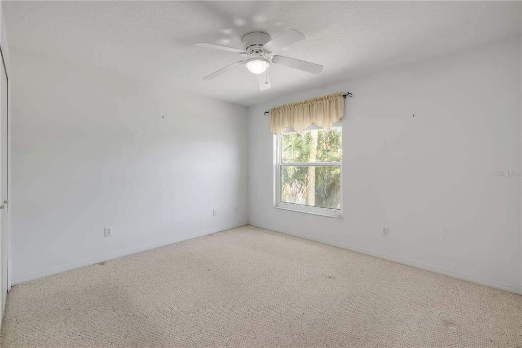 192 Azalea Road Edgewater, FL 32141 - Photo 28 of 94 an empty room with a window and a fan