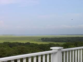Undisclosed Address West Barnstable, MA 02668 - Photo 3 of 9 a view of a green field with an ocean view